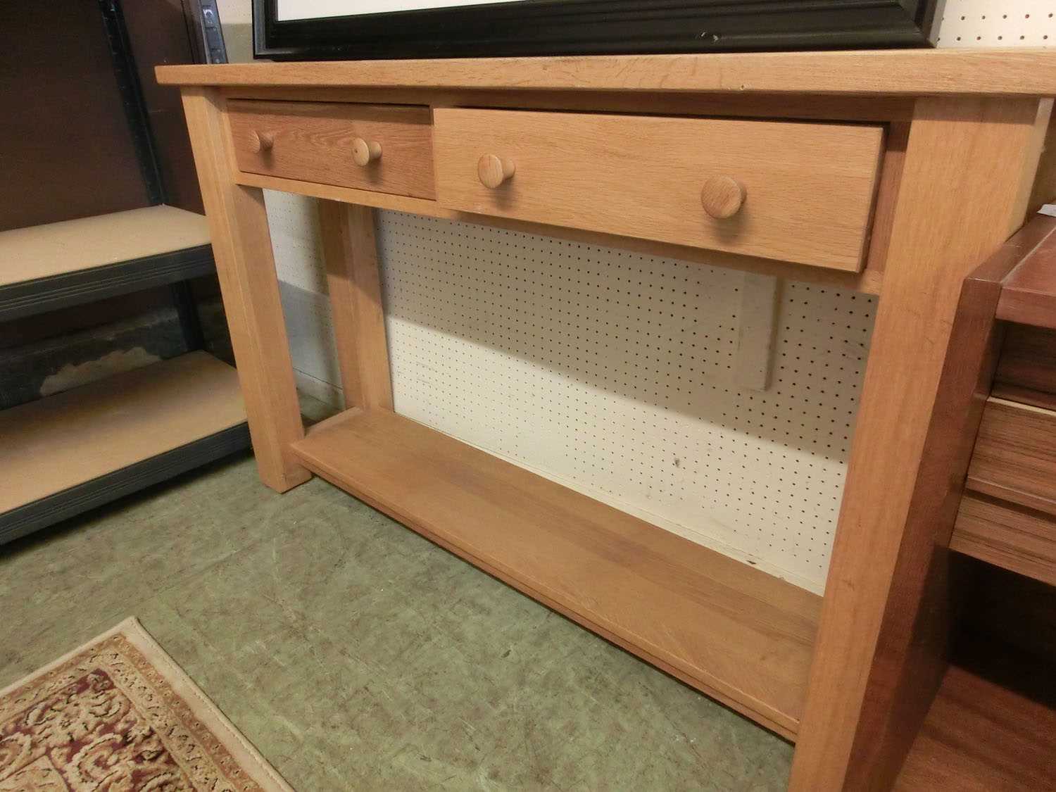 A modern oak console table having two drawers above open storageNo apparent damage to lot.