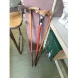 Three walking sticks, one having a horn handle with silver hallmarked collar