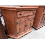 A reproduction oak cabinet having a single drawer above a pair of cupboard doors