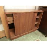 A mid-20th century teak cabinet having two sliding doors concealing two drawers