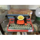 A mid-20th century tin plate junior Mettype typewriter with original box