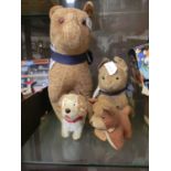 A collection of four stuffed toy dogs
