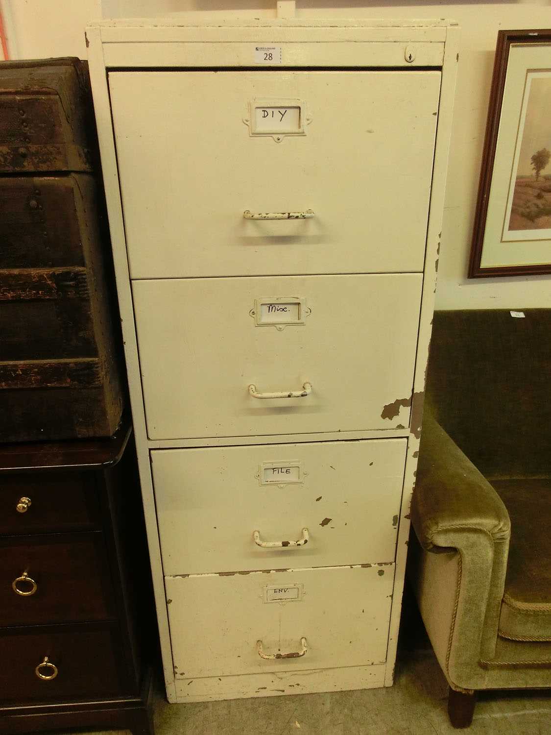 A white painted wooden four drawer filing cabinet