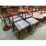 A set of four mid-20th century teak dining chairs