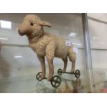 An early 20th century child's push along sheep