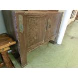 A mid-20th century oak veneered sideboard having two cupboard doors concealing drawers