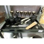 A Victorian ebonised dressing table tray with brushes, mirrors, etc,. together with a set of