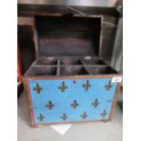 A turquoise and gold trunk bottle holder with fleur-des-Lis motifs