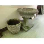 A weathered stoneware garden planter on pedestal together a weathered stoneware planter