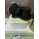 A top hat and a bowler hat along with a card hat box