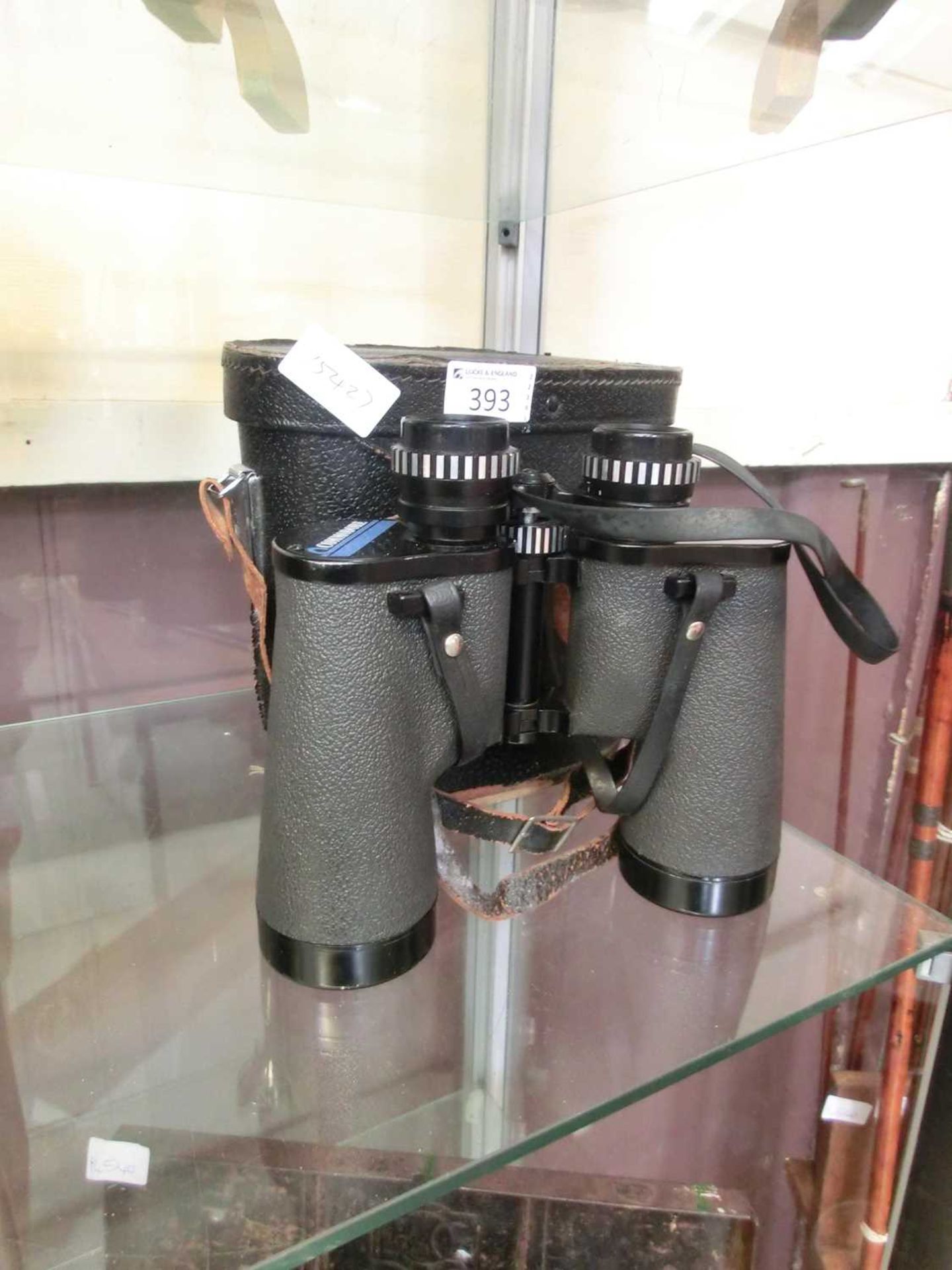 A pair of 12 by 50 binoculars with case