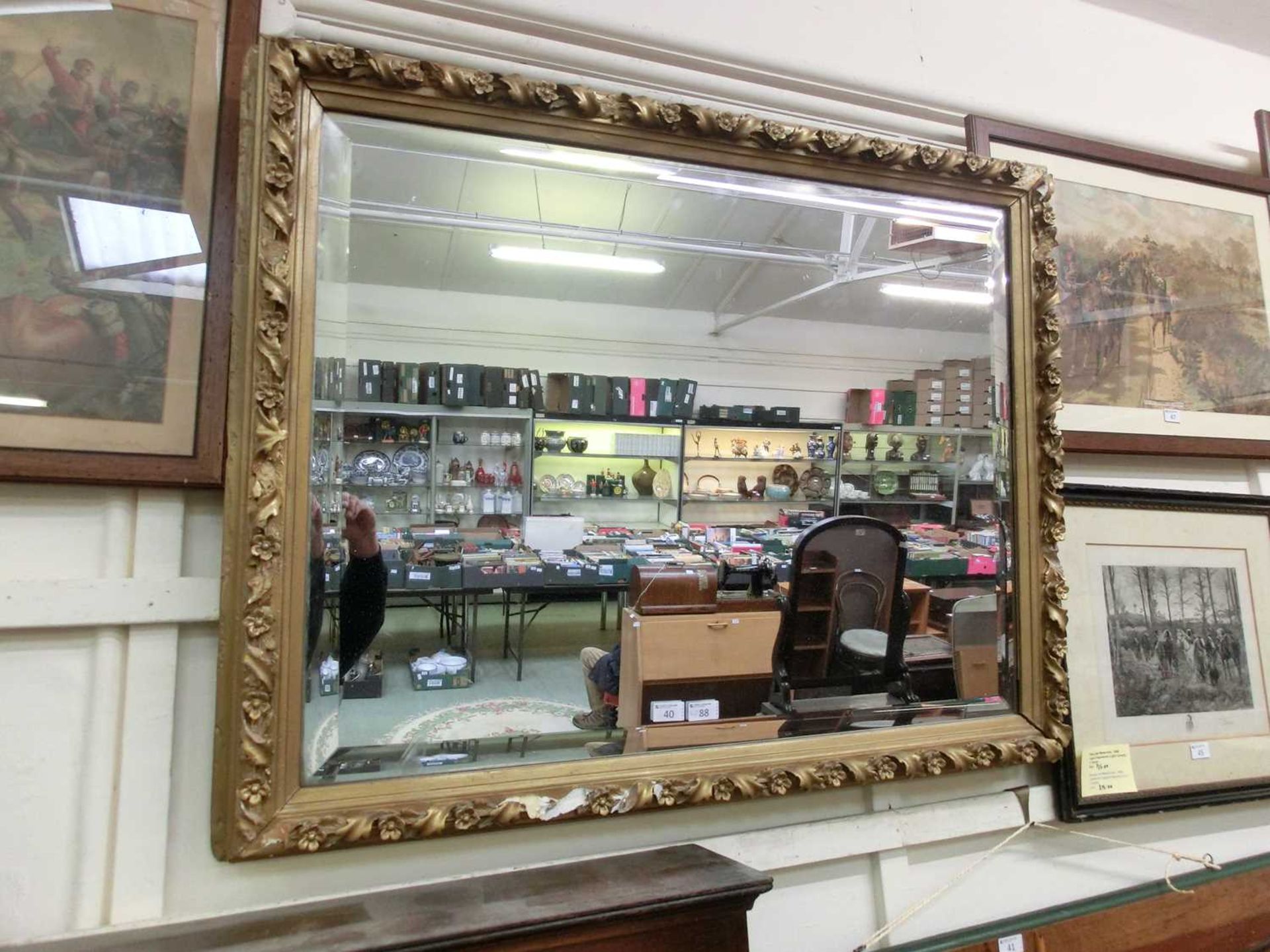 An ornate gilt framed bevel glass wall mirror