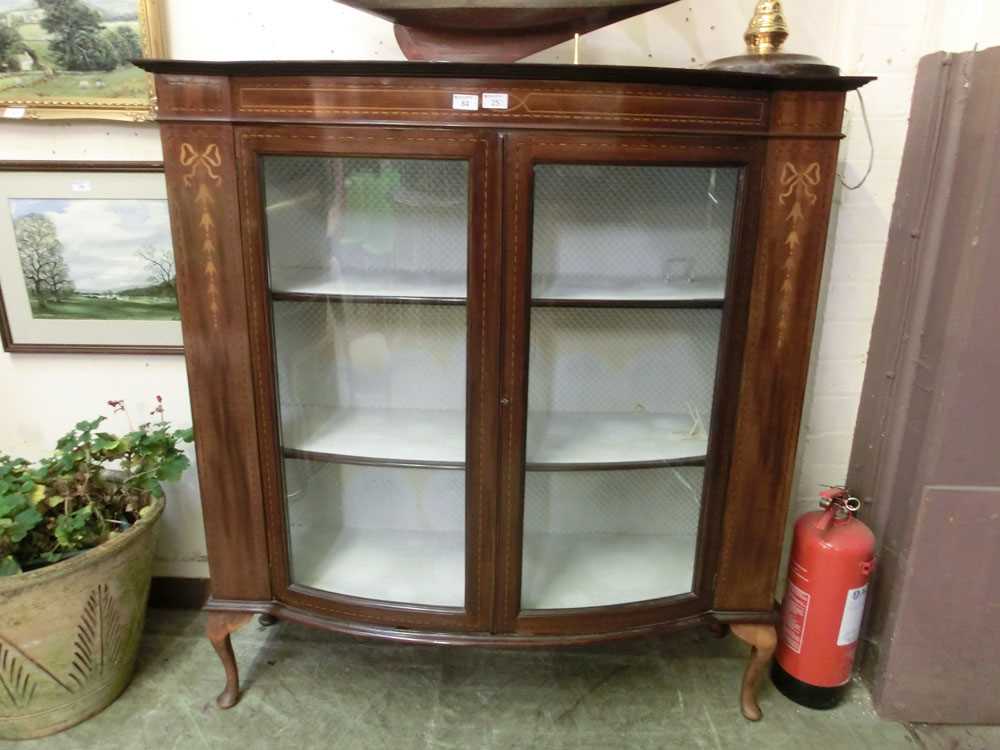 An Edwardian mahogany, marquetry, and boxwood strung bow front display cabinet