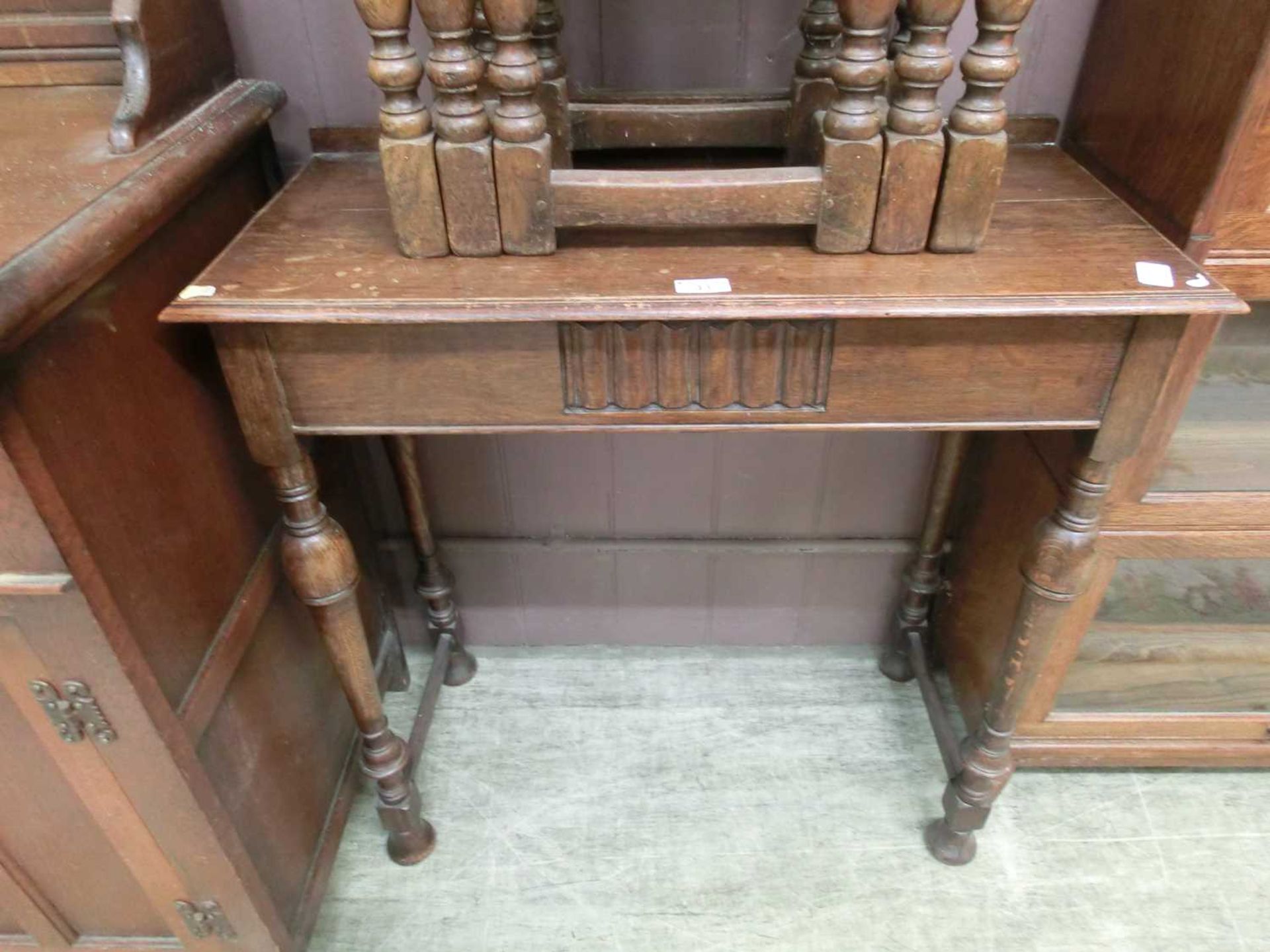 An early 20th century oak side table on turned legs