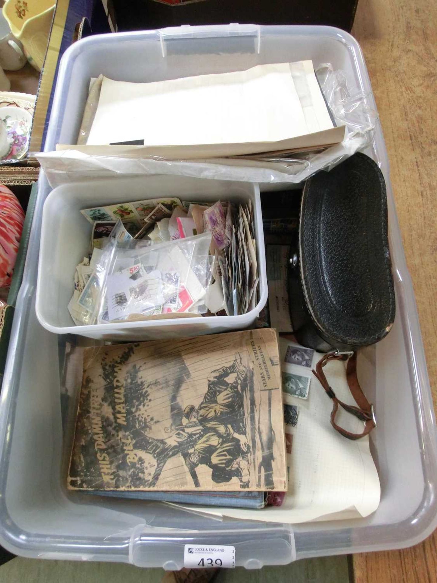 A PVC carton containing a quantity of used stamps, a pair of binoculars, etc