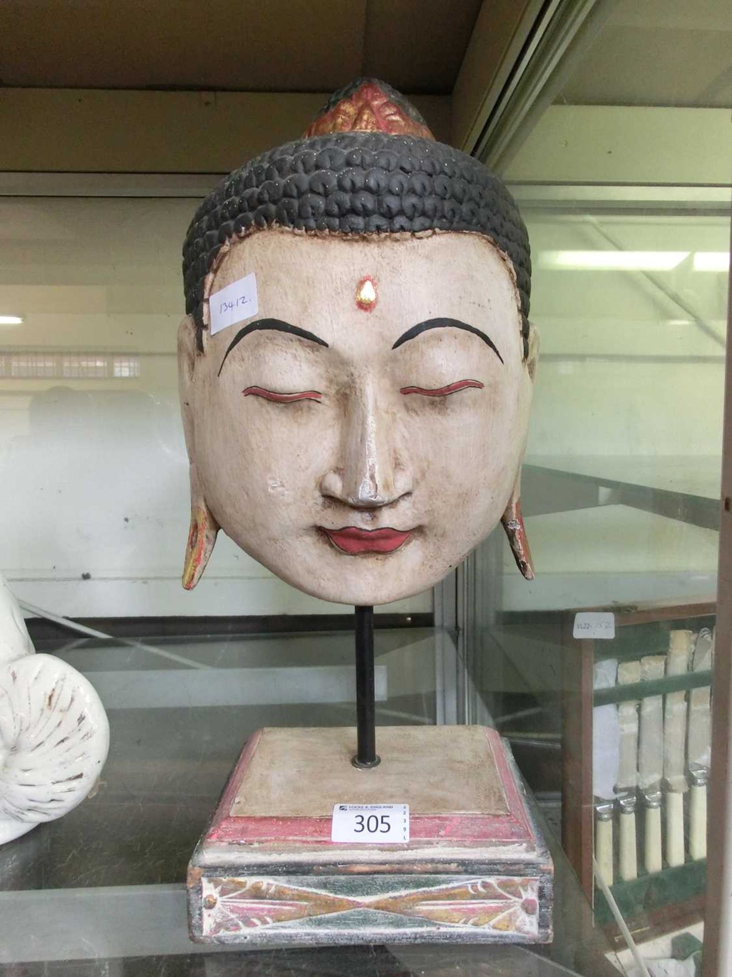 A reproduction carved wooden eastern head