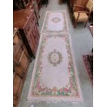 A pair of Chinese style cream ground rugs