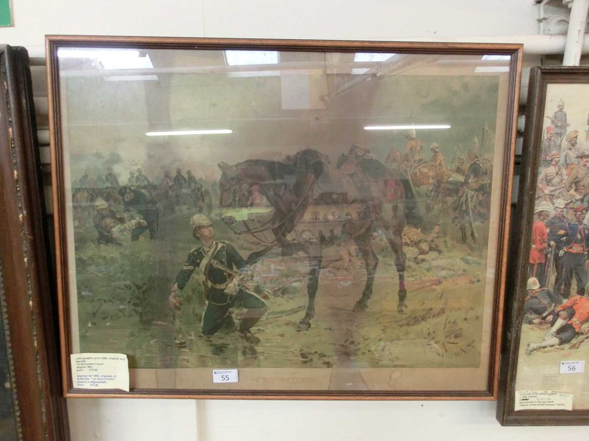 A framed and glazed lithograph 'A Wounded Friend, Afghan War' after the original by R.Neville