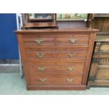 An Edwardian walnut chest of two short over three long drawers