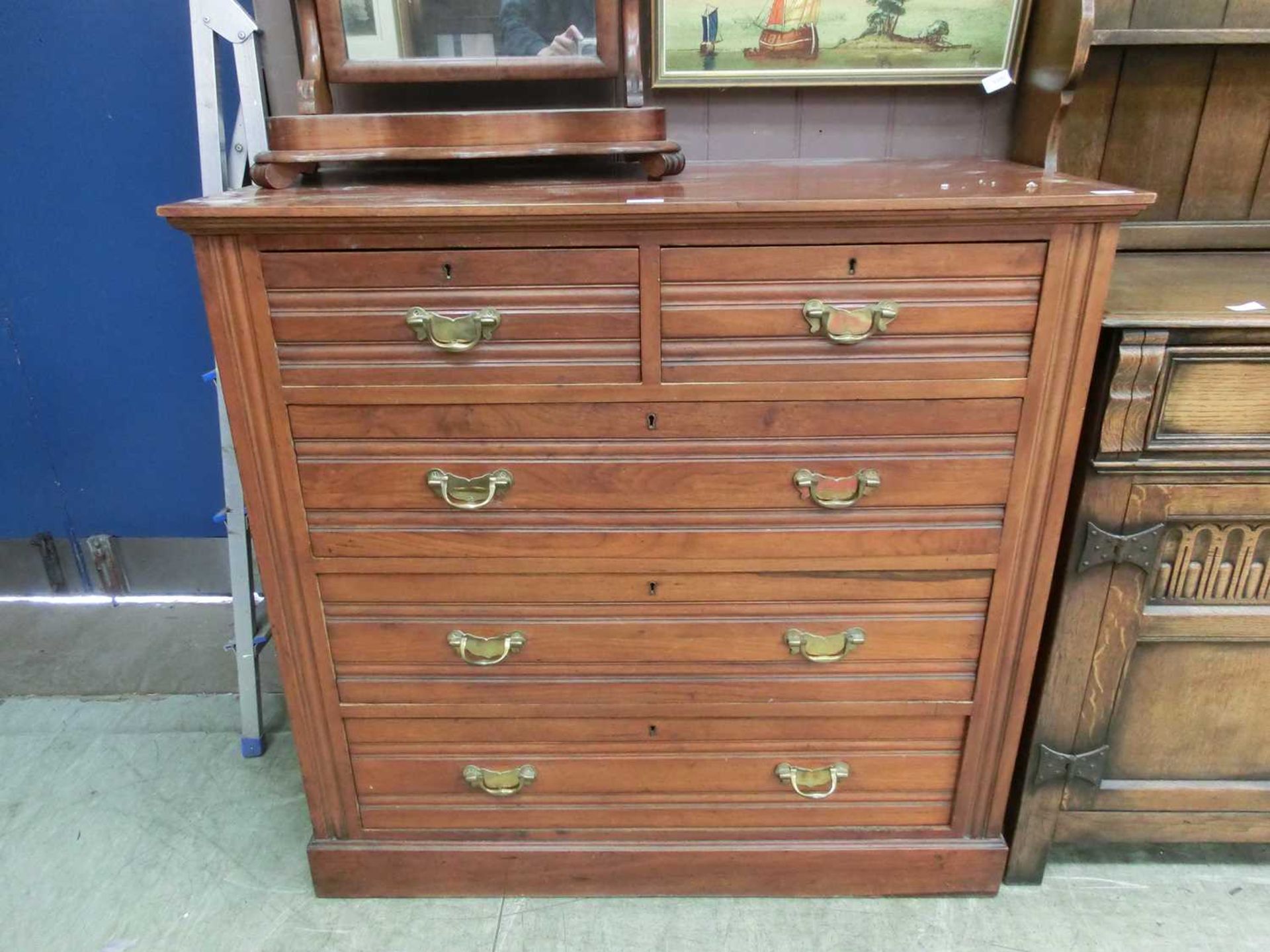 An Edwardian walnut chest of two short over three long drawers