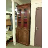 A 19th century mahogany bookcase, two glazed doors over the base with arch panelled flame mahogany