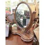 A Victorian flame mahogany swing toilet mirror