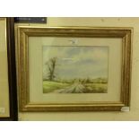 A framed and glazed watercolour of gentleman walking down country lane signed bottom right