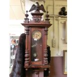 An early 20th century walnut cased drop-dial wall clock