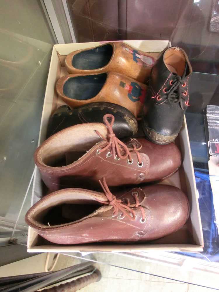 A pair of wooden clogs together with two pairs of early 20th century shoes and bootsLengths: Brown