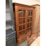 A modern wooden two door display cabinet with two drawers to base