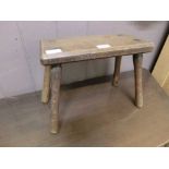 An early 20th century oak rectangular hand crafted wooden stool