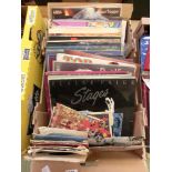 A tray containing LPs and 45 rpm records by various artists