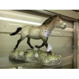 A white Beswick horse on base