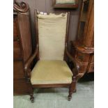 An early 20th century mahogany framed open armchair on turned legs