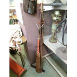 A selection of long handled wooden items to include cricket bat, hiking stick, set square, etc