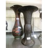 A large eastern metal vase along with a large cloisonne vase.Eastern metal vase shows large