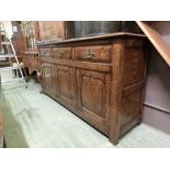 A high quality reproduction oak dresser base, the top over three drawers and three field panel