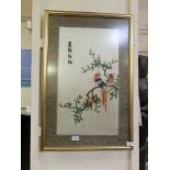 A framed and glazed oriental style silk artwork depicting birds on branch