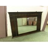 An early 20th century oak cased bevel glass over mantle mirror