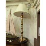 A brass columned over sized table lamp