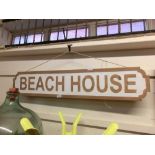 A reproduction wooden sign 'Beach House'