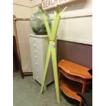 A modern metal yellow painted hat stand