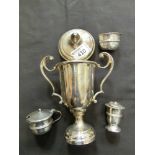 A twin handled engraved trophy with a salt and mustard pot and silver hallmarked pepper pot, approx.
