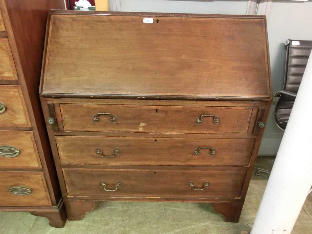 An early 20th century mahogany and tulipwood banded bureau