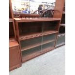 A mid-20th century two tier glazed bookcase