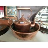 A copper kettle with a copper basin