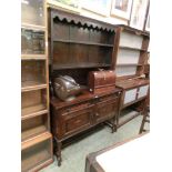 A mid-20th century dresser having plate rack to top, the base having two drawers above a pair of