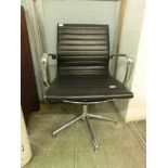 A mid-20th century design office chair, black leather upholstery on chrome five star base