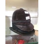 A bowler hat together with a riding hat