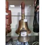 A wood handled brass bell along with part of a brass bell (A/F)